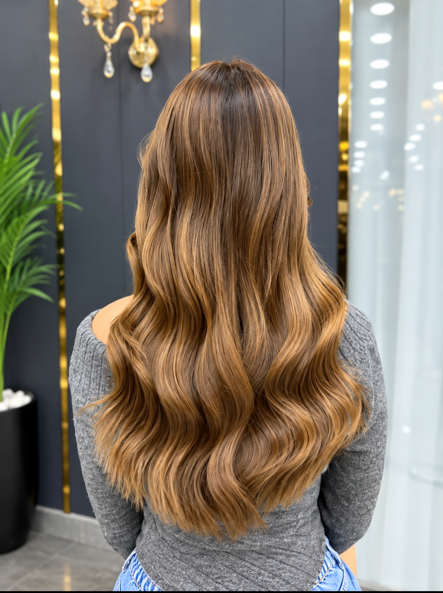 Long caramel highlighted hair styled in soft waves